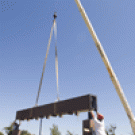 A crane lowers the Morris Fountain&acirc;&#128;&#153;s crossbeam into place as workers prepare to bolt it to the concrete pillars on July 27. Water will shoot up pipes in the columns, then fall in a sheet&acirc;&#128;&#148;like a theatre curtain&acirc;&#128;&#148;from the crossbeam. 