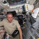 Photo from space: Aggienaut Stephen Robinson on the aft flight deck of space shuttle Endeavour during Day 1 activities Feb. 8.