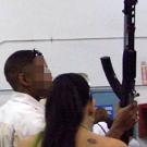 Photo shows a woman allegedly making a straw purchase of an SKS rifle with a high-capacity magazine and a bayonet.
