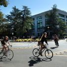 Students bicycle near Shields Library.