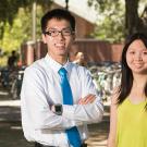 Man in white shirt and tie and woman in sleeveless blouse poising on the UC Davis campus