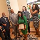 Group of people laughing with plaque.