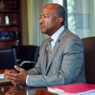 Chancellor Gary S. May sitting at a desk.