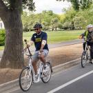 Chancellor Gary S. May riding a bicycle.