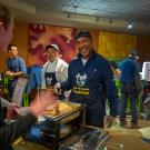 Chancellor Gary S. May serves breakfast to students.