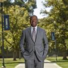 Gary S. May, smiling, posing, on the Quad.