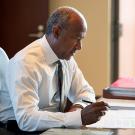 Photo of Gary S. May at desk.