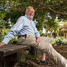Charley Hess sitting on a bench in a garden