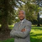 Photo of the chancellor on the quad with his arms crossed.