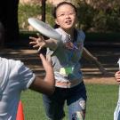 Three Chinese girls playing Frisbee