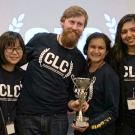 Six students pose with trophy.