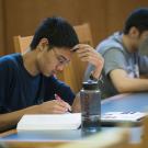 A student pores over a book in Shields Library.