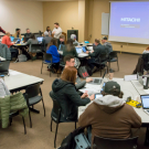 Students in groups at tables