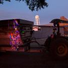 A tractor decorated with Christmas lights.