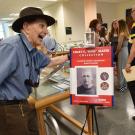 Edward Slater stands next to a poster of Colby "Babe" Slater.