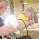 Woman in lab inspecting a potato