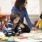 Toddlers doing puzzles on the floor