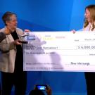 Katie Murphy receives a trophy and giant check.