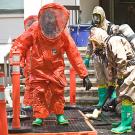 UC Davis firefighters wearing orange hazmat suits