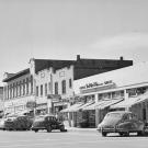 A 1951 photo looking south on G Street in Davis shows shops and vehicles. 