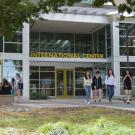 Four people walk near the entrance to the International Center.