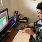 Student sits in front of computer.