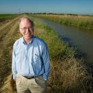 Jay Lund poses in wetlands.