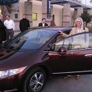 Woman about to get ready to get into a sleek purple car