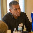 UC Davis Police Chief Joe Farrow sits at a table with other attendees.