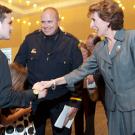 The chancellor shakes hands with Carmichael children.