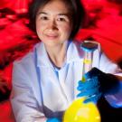 Larissa Miyachi holding a flask with yellow colored liquid