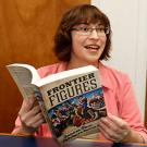Photo: Musicologist Beth E. Levy, associate professor, holding her book, "Frontier Figures"