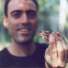 photo: man holding lizard