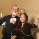 Man and woman with floating cards and magician rings 