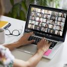 A student participates in an online class using a laptop