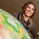 Amy Myers Jaffe, left, and Paul A. Griffin behind a big world globe