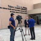 Photo: TV crew interviews a man in front of the new lab.