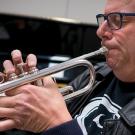 A man plays the trumpet.