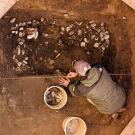Photo: Person excavating oyster shells with bucket