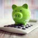 Piggy bank on top of calculator