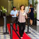 Woman walks along red carpet.