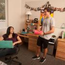 Two resident advisors in a resident hall room