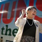 Sister Simone Campbell in front of a bus