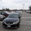 Cars parked in aisle of parking structure.