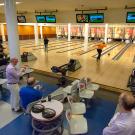 Staff members bowl in the Memorial Union Games Area.