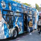 A bus decorated with photos of UC Davis athletes.