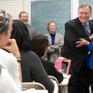Photo: Dean George R. Mangun embraces the teaching prize recipient, Professor Suad Joseph, in her classroom.