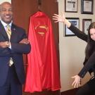 Chancellor Gary S. May and Teddy Cruz beside a hero cape