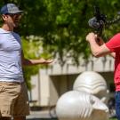 Man records video of tour guide.