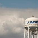 UC Davis tower against blue sky and clouds